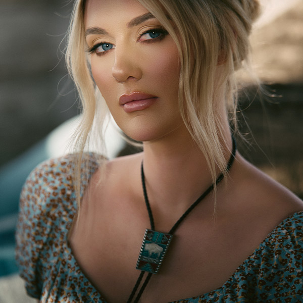 Caroline Munsick Showcasing the White Buffalo Bolo Tie