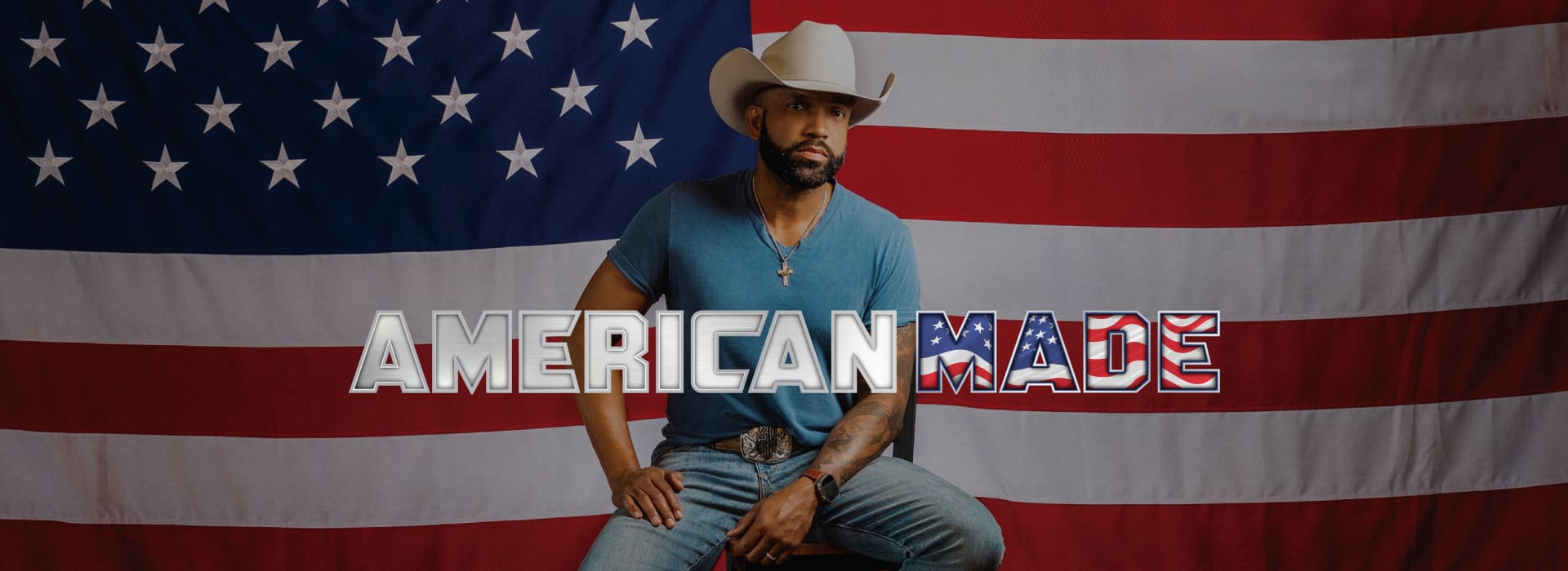 Coffey Anderson in cowboy hat in front of American flag.
