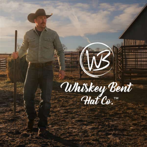 Man wearing cowboy hat wearing Whiskey Bent belt buckle. 