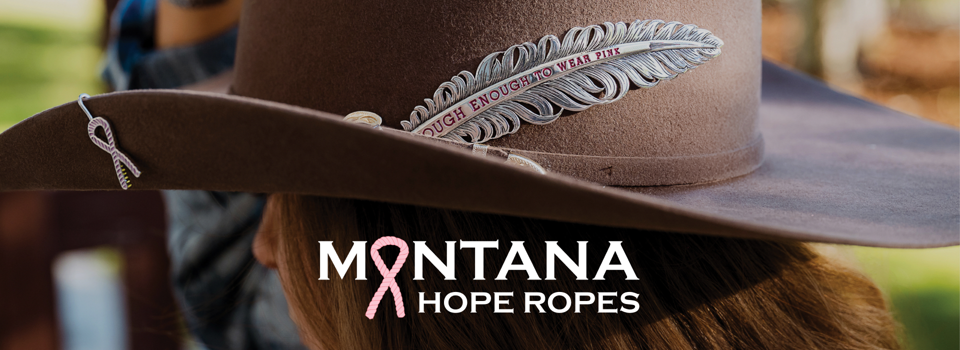 Women wearing cowboy hat with Tough Enough To Wear Pink hat feather.
