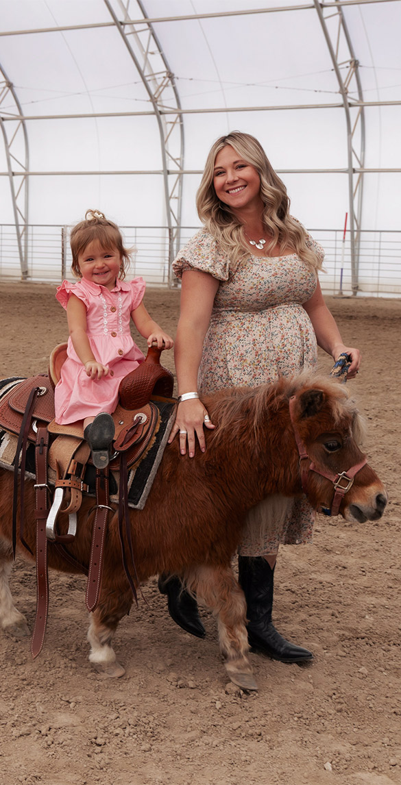 Mom and Daughter Riding Pony