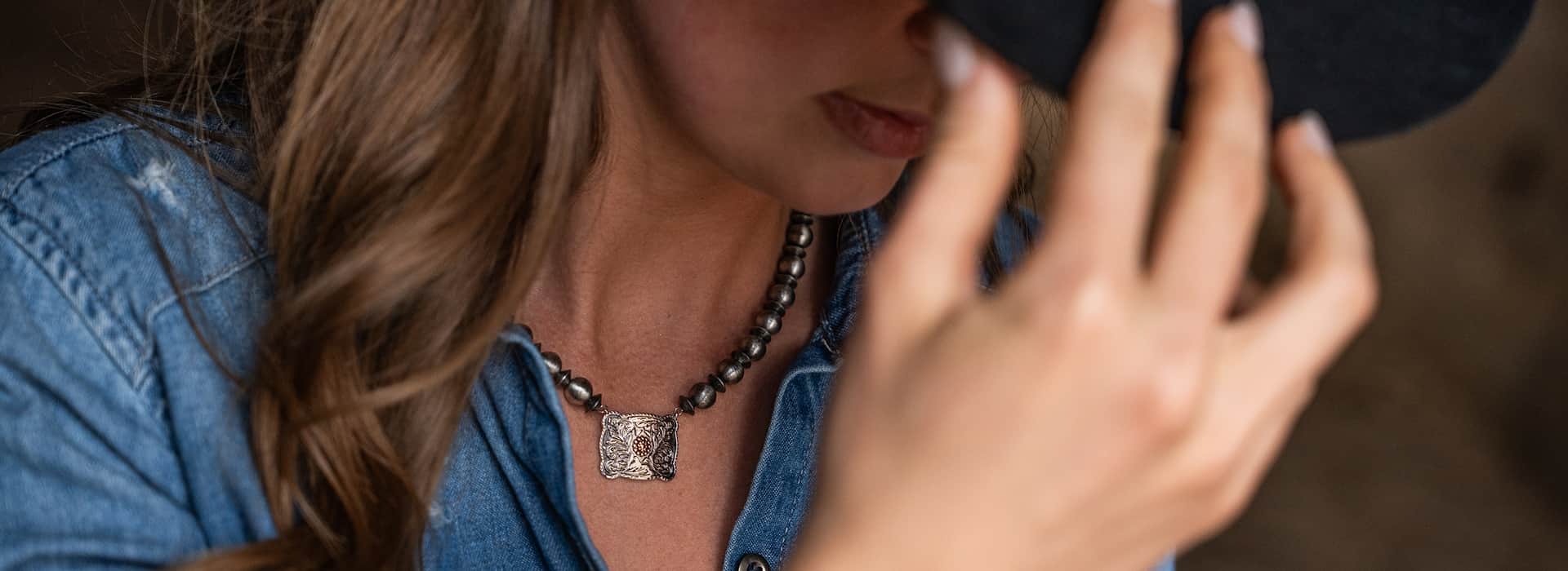 Women wearing beaded buckle necklace