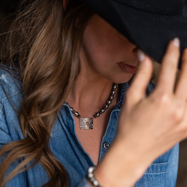 Women wearing beaded buckle necklace