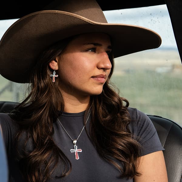 Women in cowboy hat with cross jewelry 